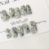 Artistic press-on nails with a silver and grey design, featuring metallic accents, displayed on a white card from EasyPressOn.com : Tiiti Ho Nail Studio.