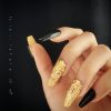 Luxurious press-on nails with a black and gold foil design, displayed on a card from EasyPressOn.com : Tiiti Ho Nail Studio.