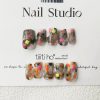 Colorful press-on nails with vibrant designs, featuring pink, orange, and neon green accents, displayed on a card from EasyPressOn.com : Tiiti Ho Nail Studio.