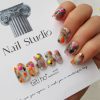 Colorful press-on nails with vibrant designs, featuring pink, orange, and neon green accents, displayed on a card from EasyPressOn.com : Tiiti Ho Nail Studio.