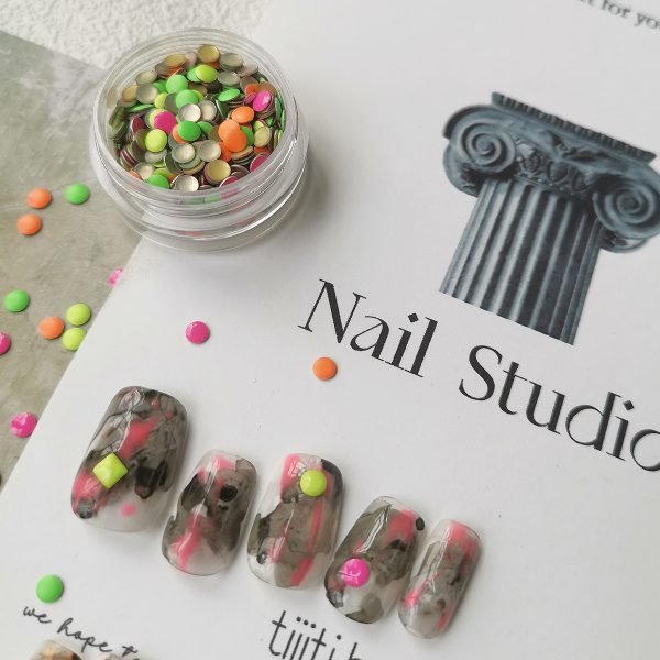 Colorful press-on nails with vibrant designs, featuring pink, orange, and neon green accents, displayed on a card from EasyPressOn.com : Tiiti Ho Nail Studio.